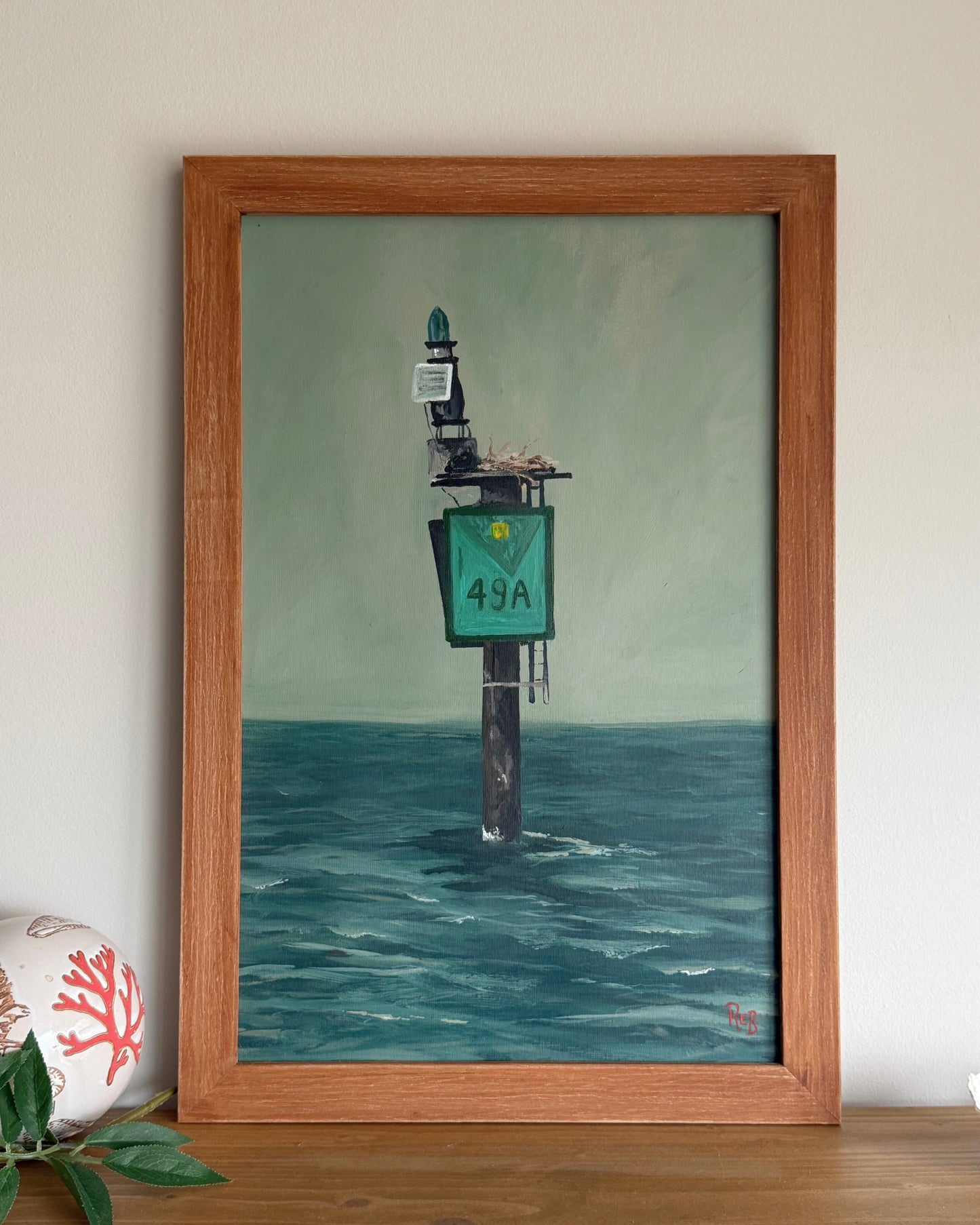 Framed painting of a mile marker in the bay.