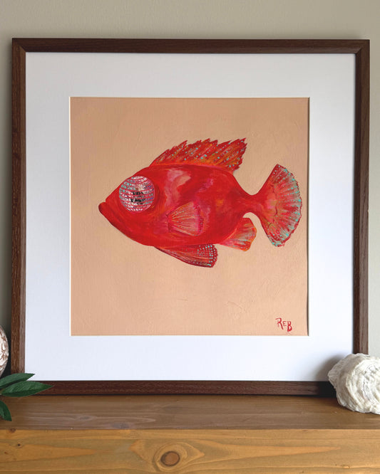 Framed artwork of a red fish on a pink background